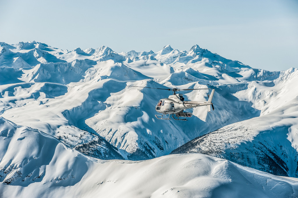 Helicopter Flying Heli Skiers In Remote Mountains In Bc, Canada